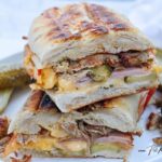 A delicious Easy Cubin Sandwich Recipe for lunch. Filled with ham, roast pork pieces, cheese, mustard, and dill pickles. Grilled in 6 minutes.