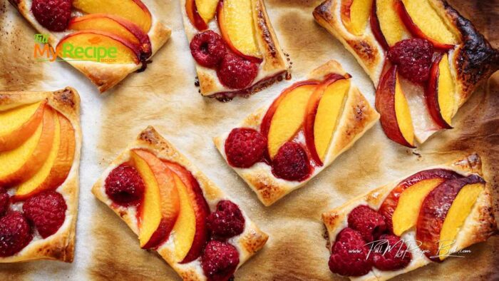 Mix the shortbread dough and press it in the dish, evenly. If it is a bit sticky add some flour to your hands.
Bake this shortbread crust for about 15 minutes. Should be golden brown. Leave to cool a little.
Slice the clean peaches with their skins on to about 1/4 inch thick. 
In a bowl add the sliced peaches, raspberries and sugar, flour, lemon juice, and vanilla. Stir and mix them up until all the peaches are coated.
Spoon and place the peaches on your baked shortbread crust. 
Place in the oven and bake for a further, 30 minutes.
