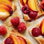 Bake Fresh Peach Shortbread Bars with raspberries recipe. A delicious dessert with every bite. Juicy oven baked peaches layered over a buttery shortbread crust.