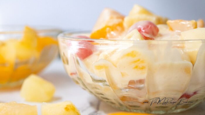 With 3 dessert bowls set aside, share your fruit mix, with some juice, equally.
Spoon in some warm custard sauce. serve