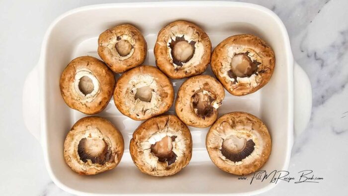Preheat oven to 175 deg. C (350 deg, F) Or grill on the barbecue.

Wash the mushrooms and remove their stems. Place upside down with the hollow showing up side, in a baking pan or a dish. Brush the mushrooms with a little olive oil.