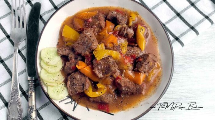 Tender beef, bell peppers, and onions simmered in a savory sauce. A crock pot pepper steak meal that is an effortless dinner recipe. Perfect for busy nights.