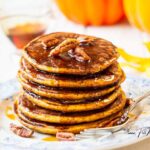 Easy homemade Fluffy Pumpkin Pancakes with pecan nuts and caramel sauce, a cozy breakfast recipe for fall mornings or seasonal treats.