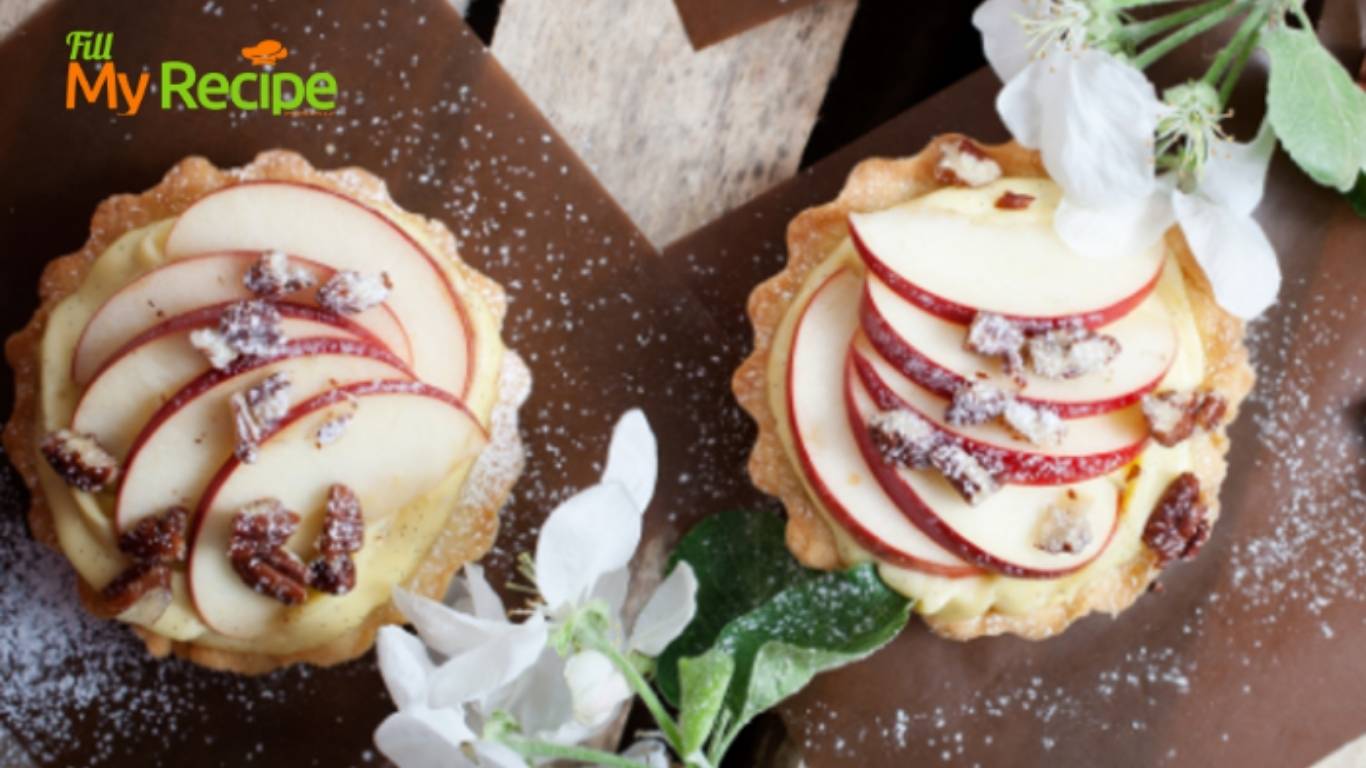 Mini Apple Cream Tartlets recipe with baked shortbread pastry for tarts. Filled with creamed apple sauce, slices of fresh apples for dessert.