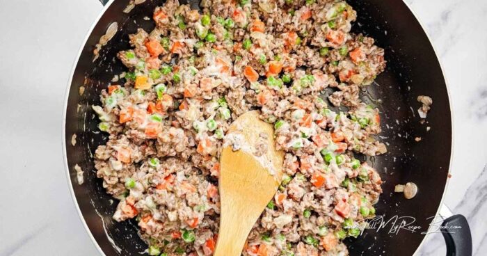 Preheat the oven to 400 deg. F (200 deg. C)

Grease a 9x13-inch casserole dish.

Dice the onion.

Cook the ground beef and onion in a large skillet over medium heat, breaking the meat apart as it cooks, until no longer pink. Drain any grease.