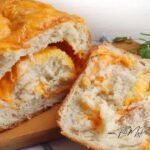Homemade No Knead Cheese Bread with a golden crust and cheesy center. Simple to make, with rising time needed, perfect for relaxed baking.