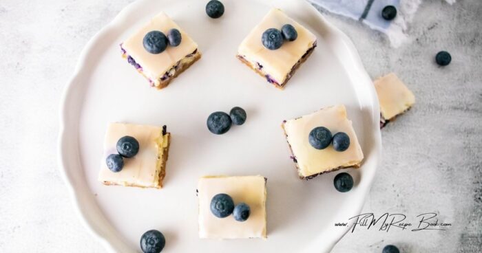 Cover the cheesecake and place in the refrigerator for at least 3 hours.
Once chilled, take out and cut into 16 squares.
Serve with fresh blueberries and enjoy.