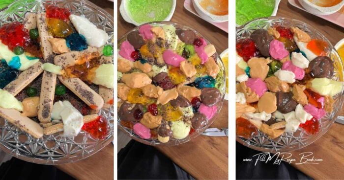 Taking the set jellies and milk pudding out of the fridge and spooning different colors around the bottom of the bowl on top of the finger biscuits. (adding about a tablespoon of each color)
Start to layer your trifle with the biscuits again, then more spoonful's of jelly and puddings. Continue this until you get to the top.