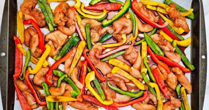 Preheat the oven to 200 deg. C (400 deg. F)
Cut the peppers into strips and dice the onion. Cut the chicken into strips.
Add the chicken and peppers to a bowl and pour in the teriyaki sauce. Cover and chill for 30 minutes for a bolder flavor.
Add a little olive oil to the sheet pan, or line a baking sheet with parchment paper. Arrange the chicken and peppers in an even layer.