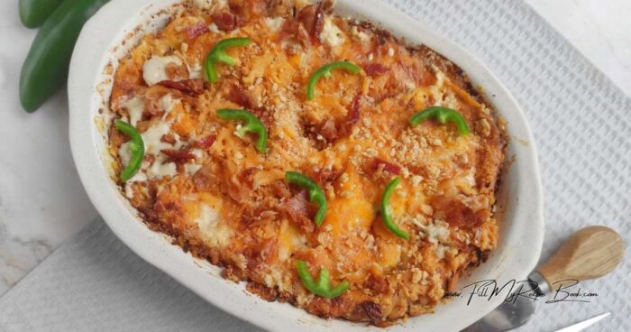 Add one cup each of grated cheeses, jalapeños, and three quarters of the bacon. Stir until evenly distributed.
Transfer the cheese mixture to a ceramic baking dish. Sprinkle with mozzarella, cheddar, cracker crumbs, and the remaining bacon. Bake in the oven for about 30 minutes and serve hot.