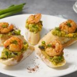 Easy chili shrimp guacamole toasts are a quick, flavor packed appetizer made with spicy shrimp, creamy guacamole, and crisp toasted bread.