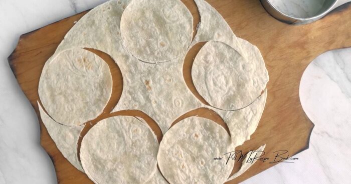 Using a 2.5-inch round cutter, form the tortillas into circles. 
Mix the oil with taco seasoning. Brush the circles with the flavored oil. Spoon 2 teaspoons of filling onto each circle and fold in half.