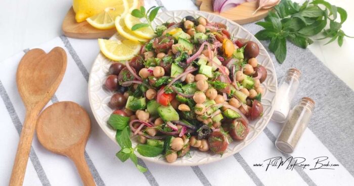 Cut the olives into rings or leave them whole. In a large bowl, combine the chickpeas, tomatoes, cucumber, onion, and olives. Add chopped herbs (dill and mint). Pour the dressing over the salad and toss gently. Taste and adjust the seasoning, if necessary.