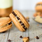Chocolate Chip Buttercream Macarons are delicate French sandwich cookies with crisp shells, chewy centers, and a smooth, creamy filling.