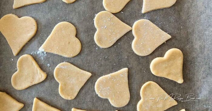 get the recipe attached.
Roll the dough on a lightly floured surface, cut out your heart shapes and place on a grease baking tray or sheet. (Roll the dough about 3–4 mm (⅛ inch) thick)
Chill the cut cookies for 10 minutes before baking to help them hold their shape.
