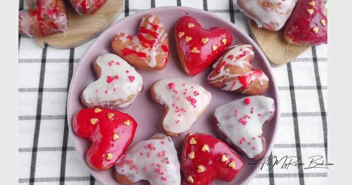 Transfer the donuts to a paper towel. Heat the chocolate glaze in the microwave on pulse mode. Cover a few hearts with white glaze, making drips with a spoon.