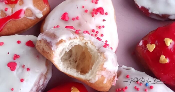 Homemade Donuts are homemade baked goods perfect for breakfast or tea. And if you make heart-shaped donuts and cover them with a vibrant chocolate glaze featuring Valentine's Day cards, you'll create a stunning dessert for your loved one. Heart-shaped donuts are perfect for Valentine's Day, a romantic dessert, or a small edible gift. Soft and airy inside and covered with a shiny glaze, they look simultaneously festive and homey, with that very taste associated with warmth and care.