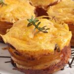 Crispy Edged Scalloped Potato Cups are baked in a muffin tin for perfectly portioned, cheesy layers with golden, crispy edges.