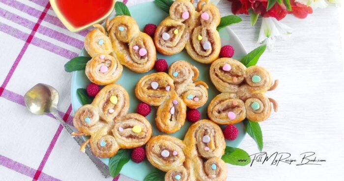 Before baking, the butterfly palmiers are brushed with egg wash for a glossy golden finish and arranged on lined baking trays with space to expand. As they bake, the puff pastry rises beautifully, creating light crispy layers with sweet cinnamon edges.