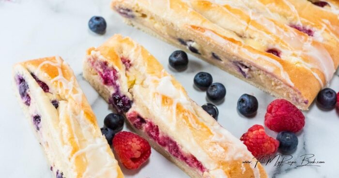 Bake a buttery Lemon Glazed Homemade Berry Danish with flaky pastry, sweet cream cheese, and fresh berries for a bakery-style treat at home.