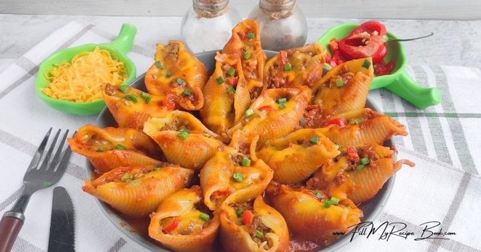 Fresh garlic adds a rich, appetizing aroma to the beef stuffed pasta shells, while spicy peppers, such as fresh red chili or jalapeño, provide a pleasant kick that harmoniously complements the seasoned ground meat and tomato sauce.